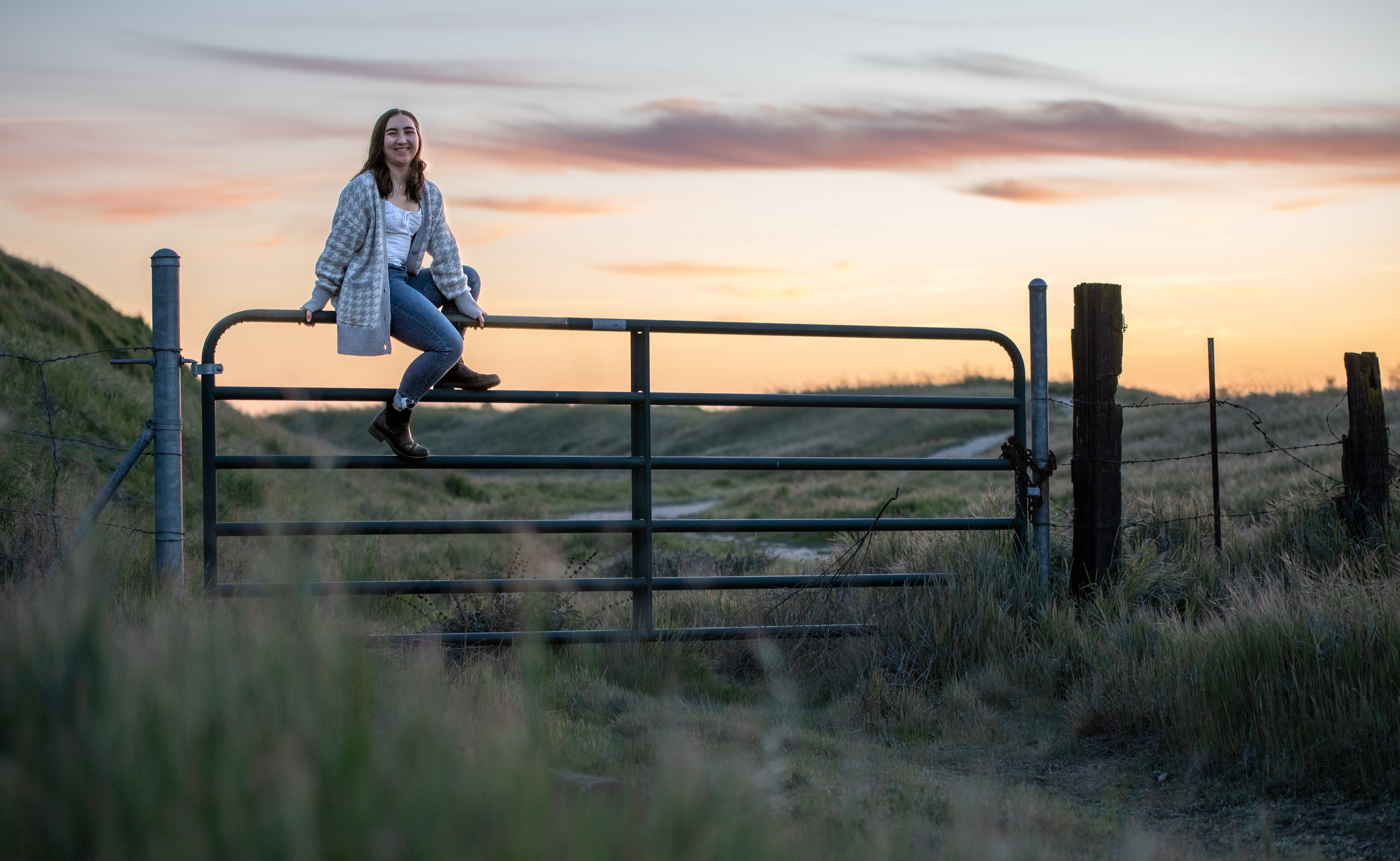 Senior portrait on gate at sunset — portrait photography
