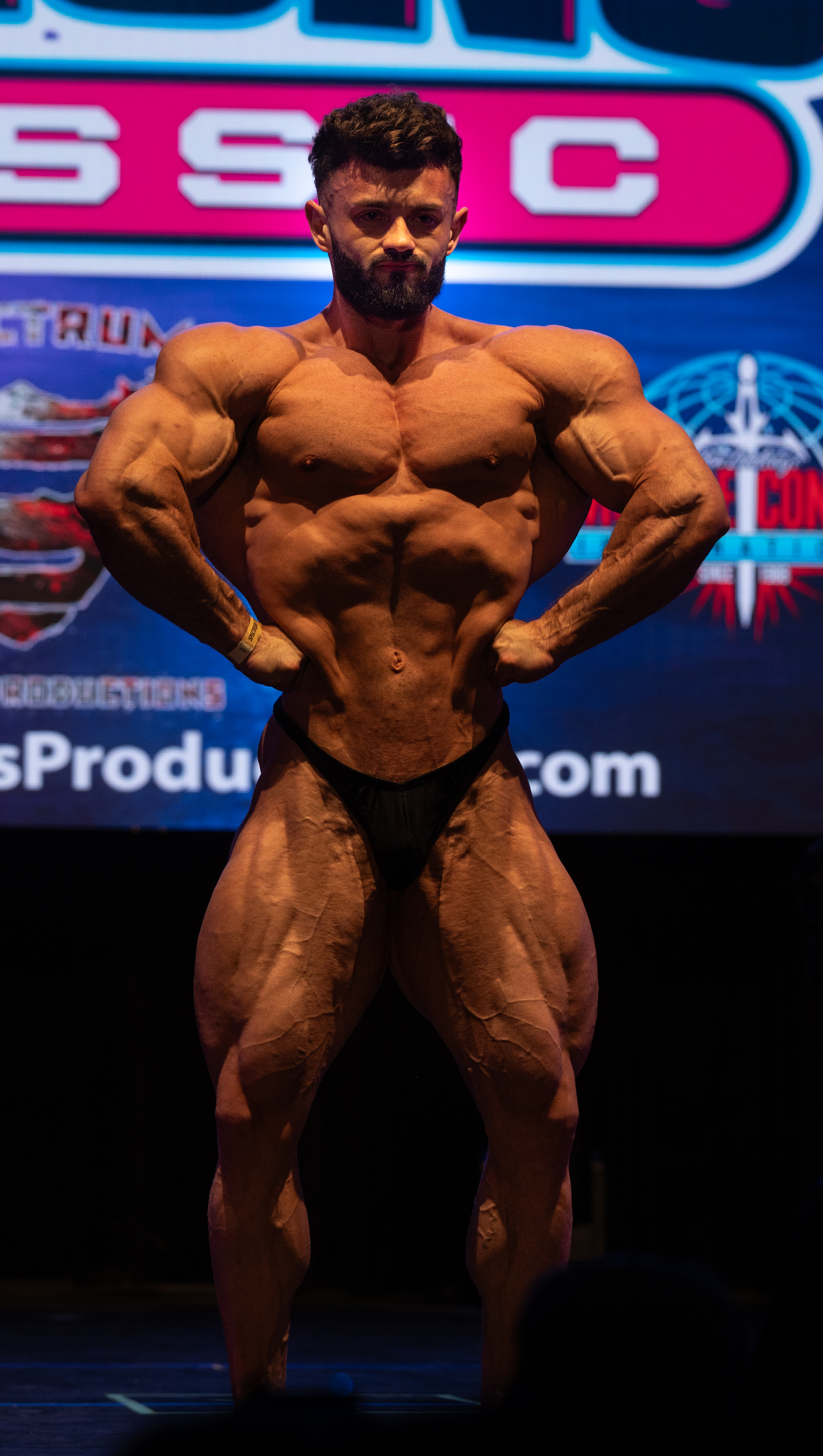 Bodybuilder guest posing on stage — fitness photography